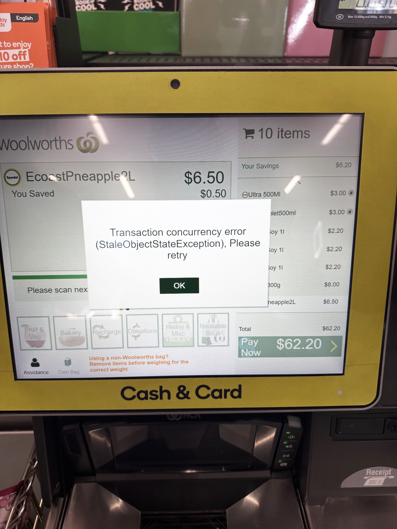 Photograph of a Woolworths self-checkout machine, with an error message:
"Transaction concurrency error (StaleObjectStateException), Please retry"